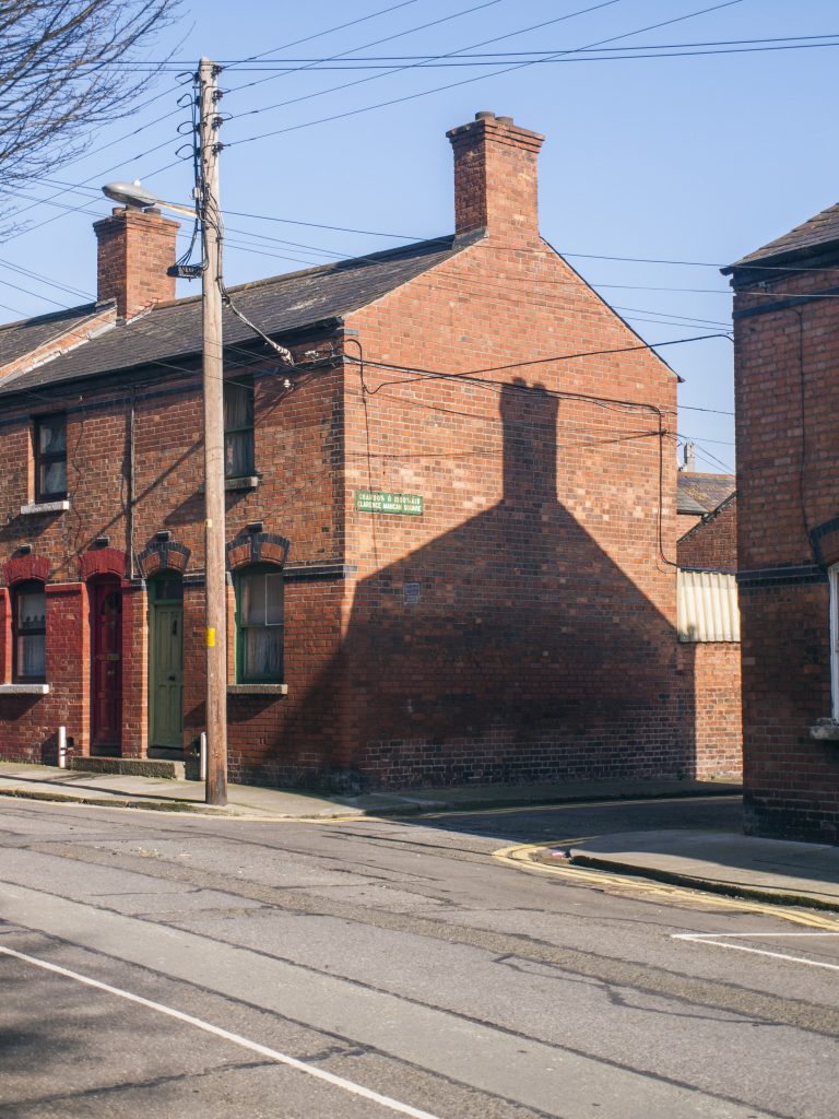 And older brick Irish home taken from across the street showing the gable end of the home.